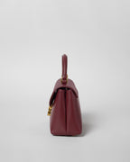 TEEN NINO BAG IN SMOOTH SATINATED CALFSKIN WITH ENAMEL CLOSURE