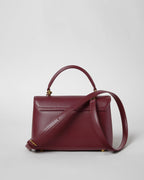 TEEN NINO BAG IN SMOOTH SATINATED CALFSKIN WITH ENAMEL CLOSURE